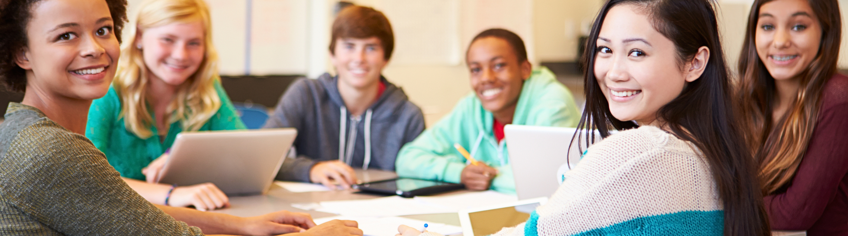 students around table smiling