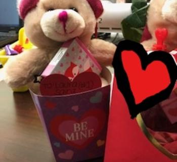 a stuffed animal bear sitting in a cup with text Be Mine